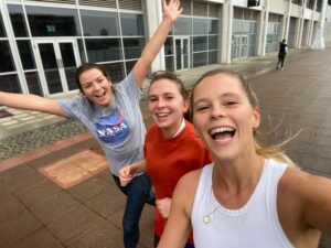 three young ladies smiling at the camera