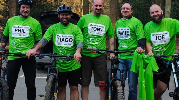 Males with bikes in Green team Arthur tops