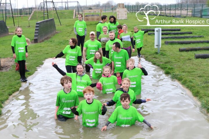 Group in Green T-shirts in Mud puddle