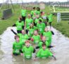 Group in Green T-shirts in Mud puddle