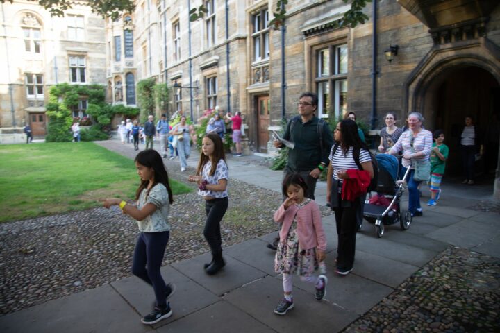 Children and adults walking through Cambridge College