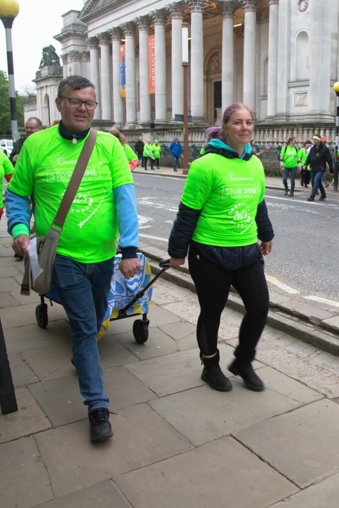 Male and female in green tshirts walking 