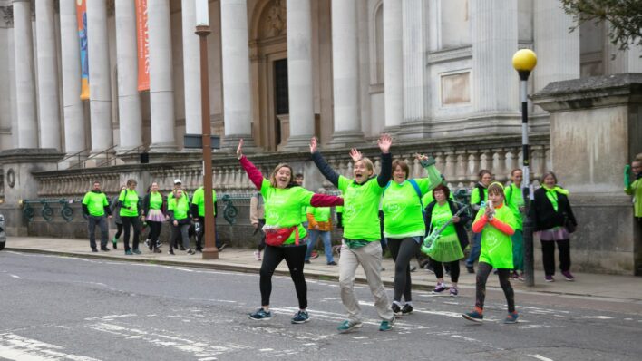 Males and females in green t-shirts outside Fitzwilliam