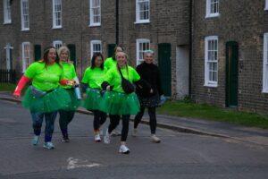 Group of females wearing green walking along Cambridge Street