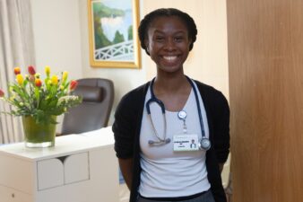 Female Dr smiling at the camera