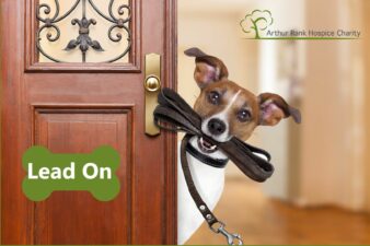 Dog with lead in mouth poking head round door with ARHC logo and Lead on