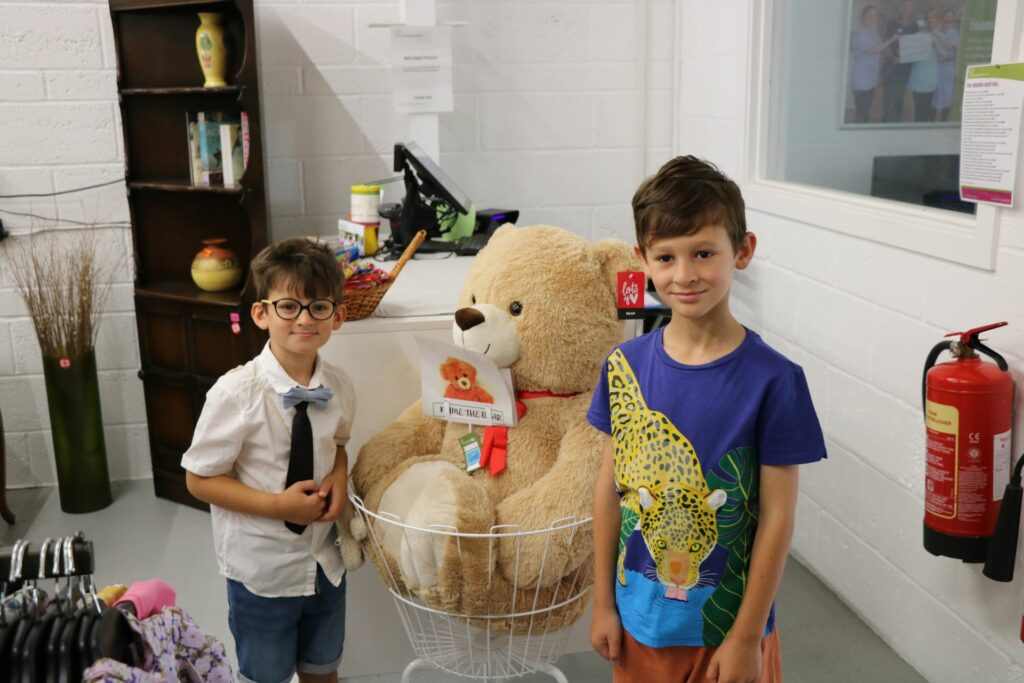 2 boys with a large teddy 