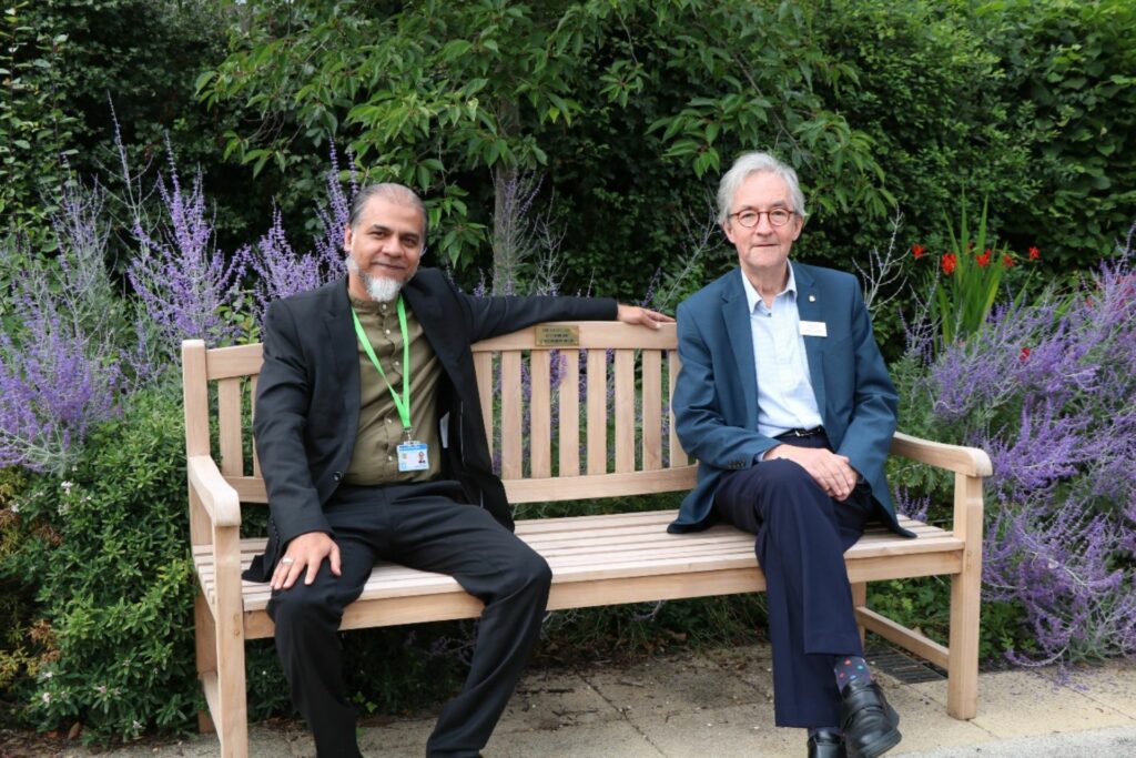 2 males sitting on a bench 