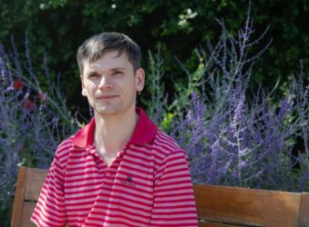 Male sitting on a garden bench