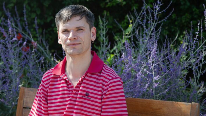 Male sitting on a garden bench