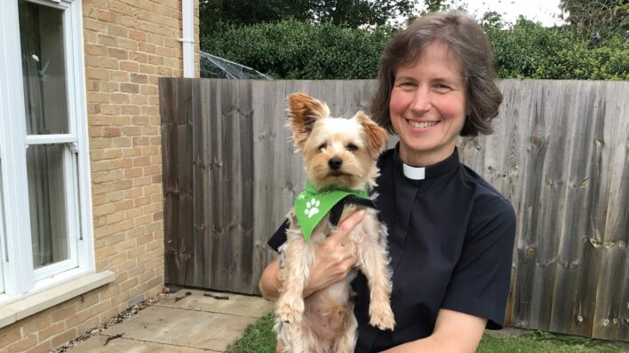 Female Vicar holding Yorkshire terrier