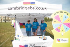 Female wearing blue t-shirts under a white branded gazebo
