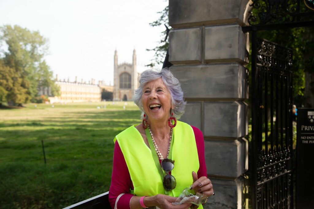 Female outside a gate with Kings College in the background