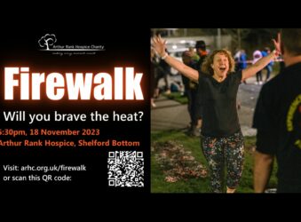 Black poster with white writing and an image of a women walking on embers with her hands in the air