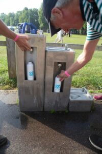 Male and water station with 2 bottles with coop branding