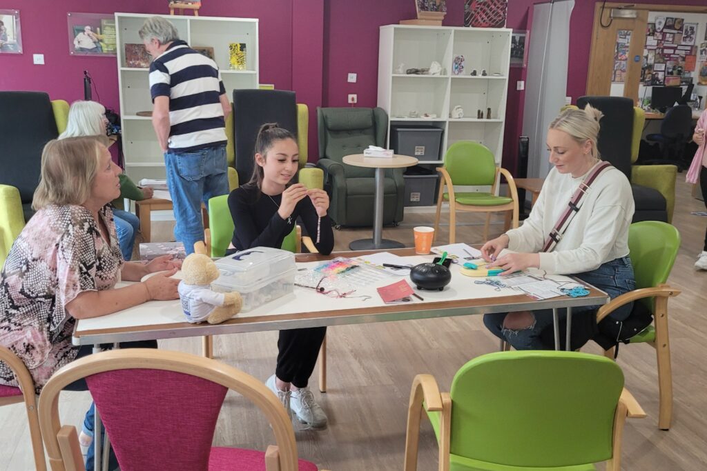 Females sitting at a craft table 