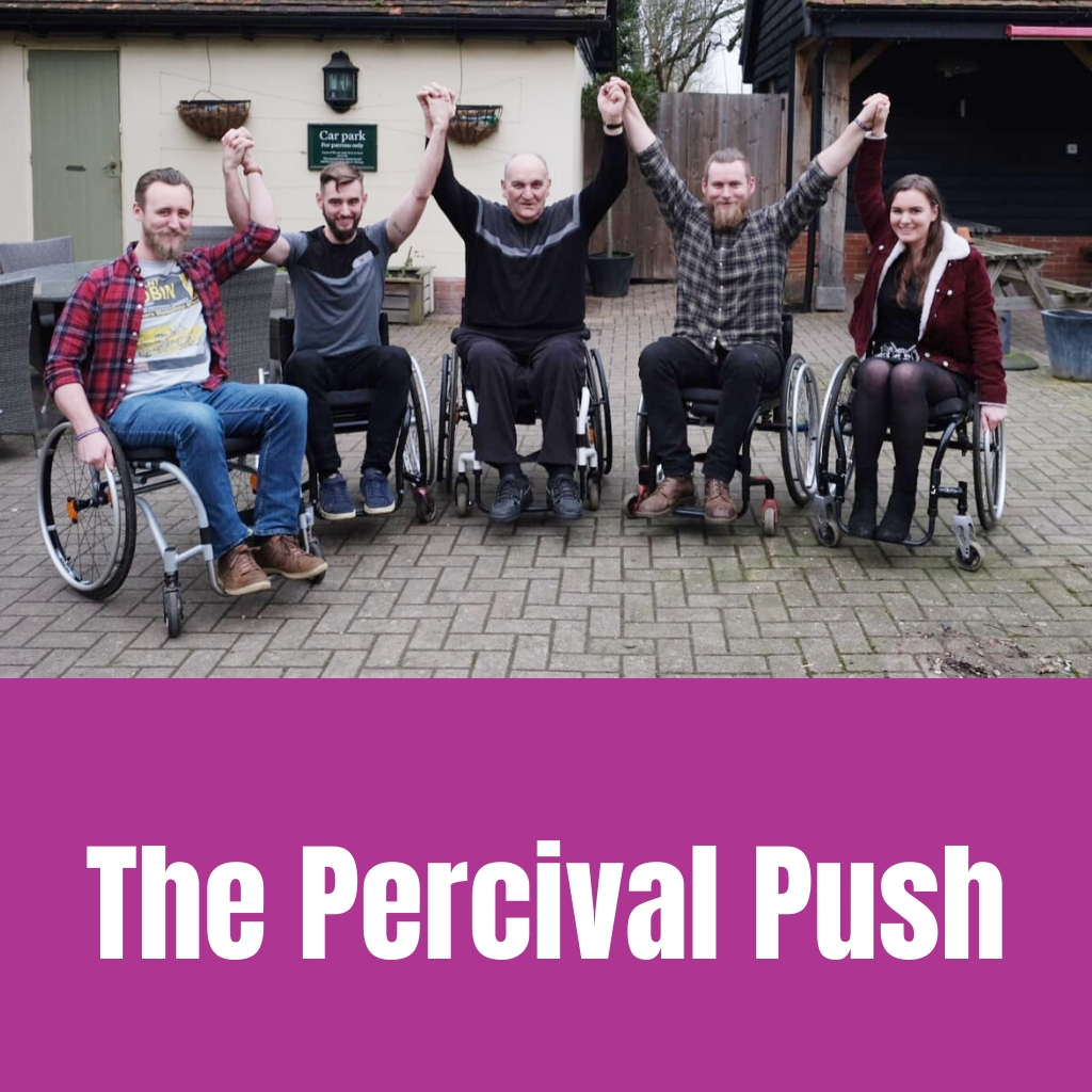 5 people in wheelchairs with their arms in the air.