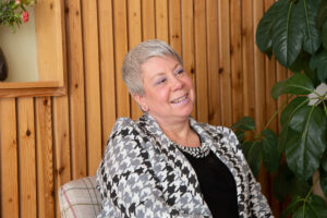 Female sitting on a chair smiling 