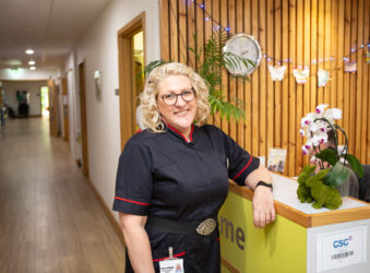 Female in nurses uniform leaning on side