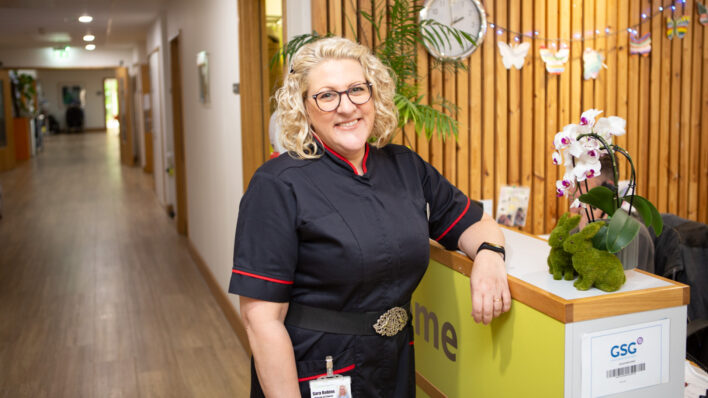 Female in nurses uniform leaning on side