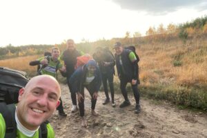 Dad's army team photo selfie, 6 men in pic wearing hiking gear smiling at camera