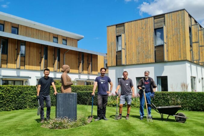 A team of corporate volunteers standing by the hospice.