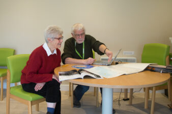 Female and male sitting at a table looking at map on the table