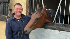 Man smiling at camera with horse