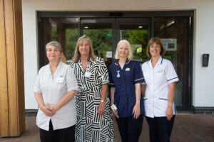 4 females 3 nurses smiling outside the Hospice