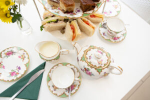 Tea pot, cups and sandwiches 