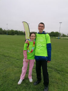 Male and female wearing bright green tops 