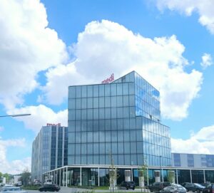 Large glass building amongst a blue sky