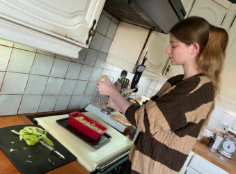 Female baking in a kitchen at the stove