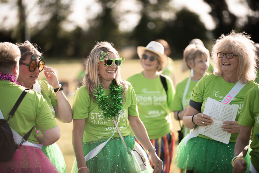 Females wearing green t-shirts outside 