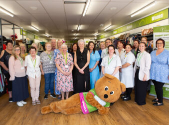 Group of adults and a life sized bear in a group