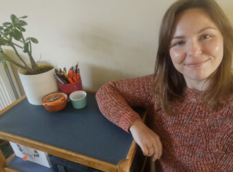 Female next to a blue trolley