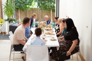 Females and male sitting at a long table