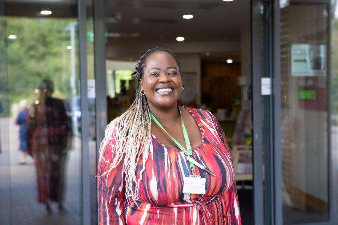 Female wearing red dress smiling at the camera
