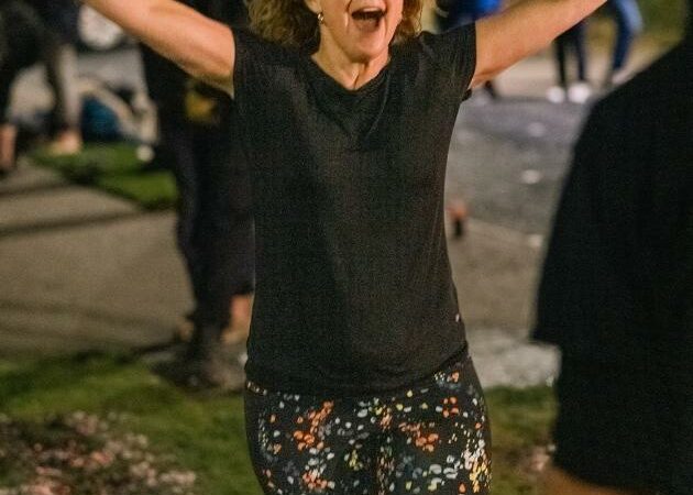 Female with hands out and mouth open near ashes