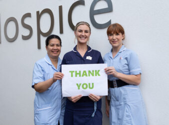 3 female nurses holding a thank you sign