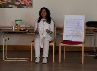 Female, wearing white sitting on a chair