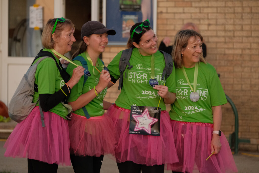 Females wearing green t-shirts and medals 