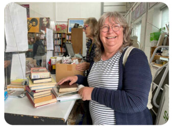 Female with books smiling at the camera