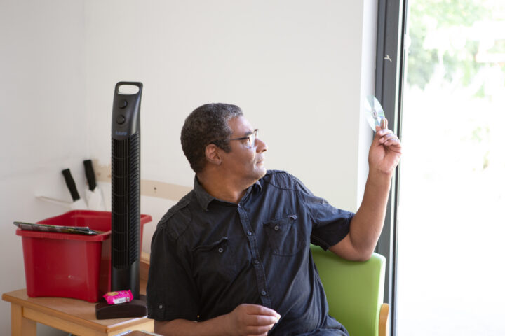 Male holding glass and looking outside