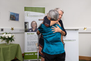 Two females hugging 