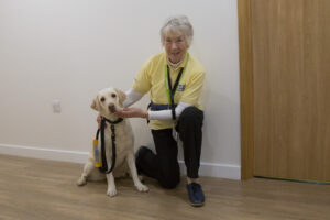 Female holding a white dog 