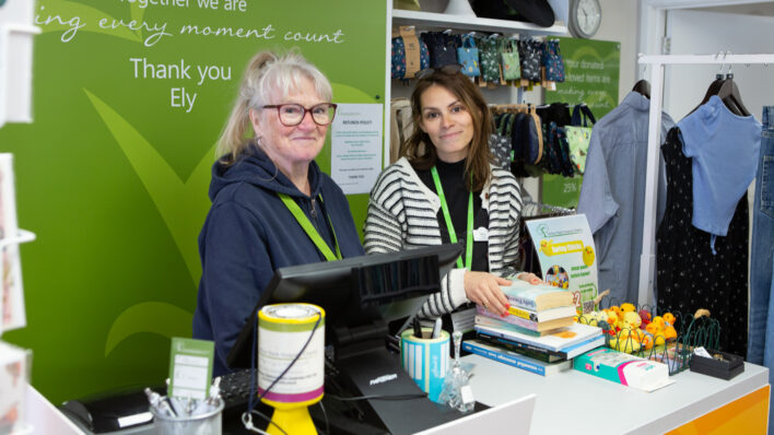 2 females standing behind a counter