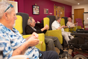 Males sitting in chairs 