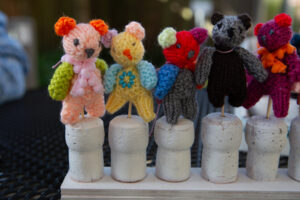 Knitted bears on a white cork 