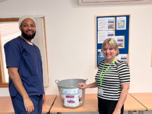 Male and female with raffle bucket